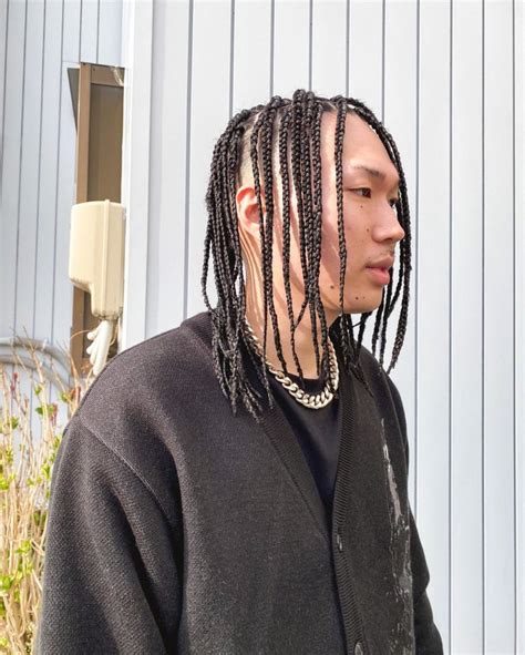 asian man with box braids.